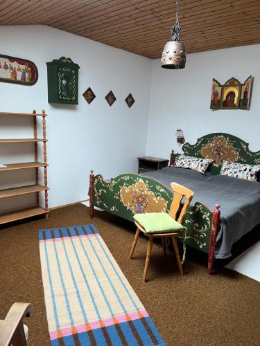 a bedroom with a bed and a chair at Ferienwohnung Ewa in Grassau