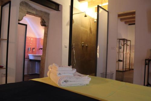 a pile of towels sitting on a table in a bathroom at Le Dimore di San Nicola in Favara