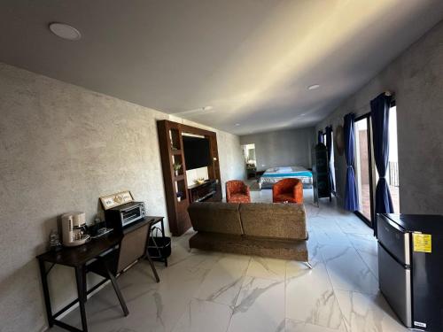 a living room with a couch and a bedroom at Casa de los Agaves in Bernal