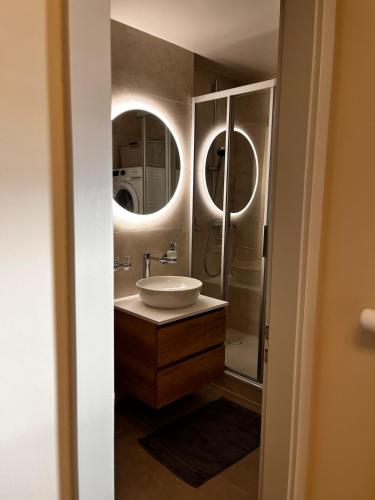 a bathroom with a sink and a mirror at Beautiful mountain apartment in Leysin