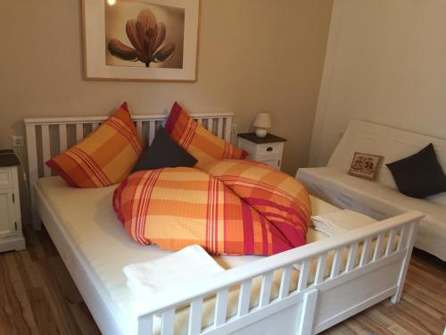 a bed with colorful pillows on it in a room at Haus Senn in Seefeld in Tirol