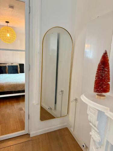 a mirror in a white room with a bedroom at Bed & Breakfast Anna in Groningen