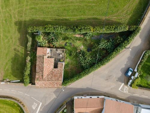 an overhead view of a house and a road at Rustic House - Eco Farm Living in Capelas