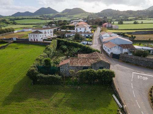 an aerial view of a small village with a house at Rustic House - Eco Farm Living in Capelas