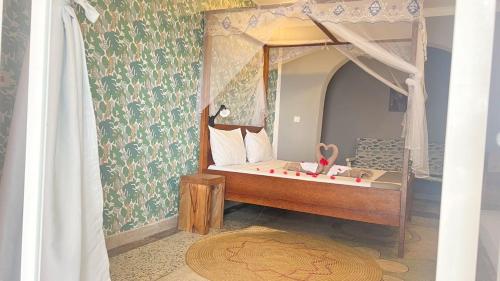 a bedroom with a bed in a doll house at Seashore hotel and Eco Bungalow in Kumba Urembo