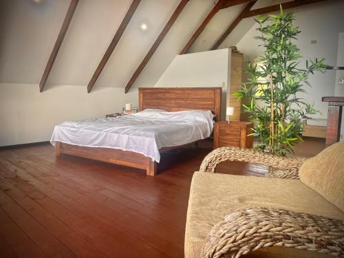 a bedroom with a large bed and a couch at Six Pillars Resort in Bocas Town