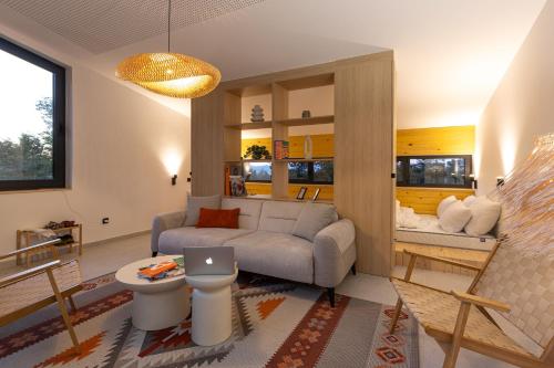 a living room with a couch and a table at BLOK Wood Cottage in Visoko