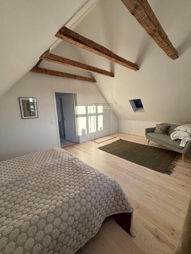 a bedroom with a bed and a couch in it at Unique Living - Herning City Central House in Herning