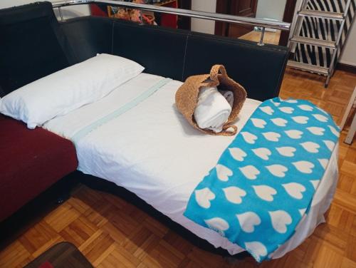 a bed with a stuffed animal sitting on top of it at Gascona con Deli in Oviedo