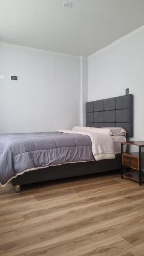 a bedroom with a bed and a wooden floor at Mirador volcanes in Santa Luisa