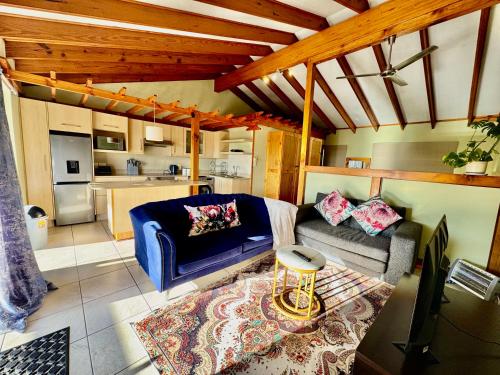 a living room with a couch and a table at Egret's Lookout in Cape Town
