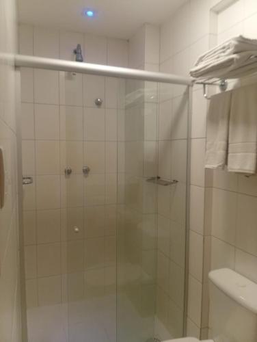 a shower with a glass door in a bathroom at Suítes Executivas in Feira de Santana