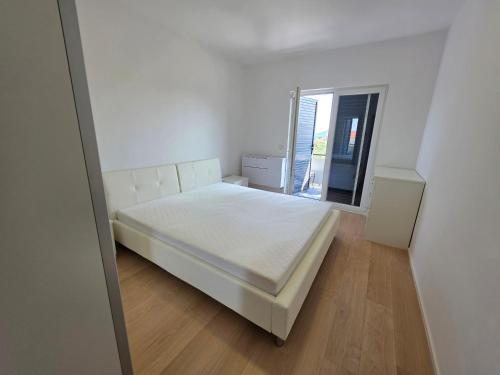 a bedroom with a white bed and a window at Ana i Marko in Vodice