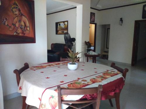 a dining room table with a white table cloth on it at Illumination Stay in Negombo