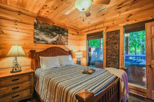 a bedroom with a bed in a wooden cabin at Goonies Cove - Spacious 4BR Cabin Arcade, Pool Table & Hot Tub! in Sevierville