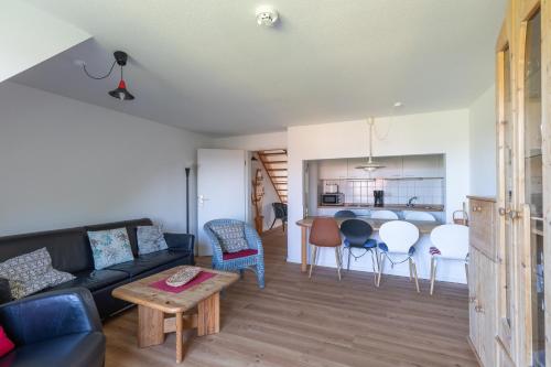 a living room with a couch and a table at Haus Stranddüne, Whg 6 in Cuxhaven
