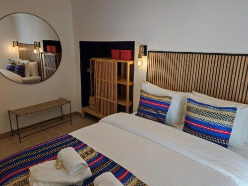 a bedroom with a large bed and a mirror at Entre Muralhas - Cozy Apartment Elvas II in Elvas