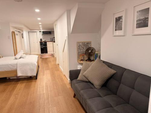 a living room with a couch and a bed at Lower level newly renovated studio apartment in central downtown location in Toronto