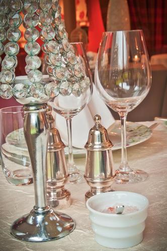 a table with wine glasses and a bowl on it at Moulin de Daverdisse in Daverdisse