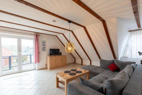 a living room with a couch and a table at Am Grooten Steen, Whg 19 in Duhnen