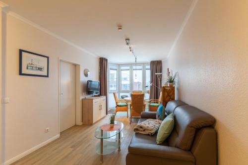 a living room with a couch and a table at Haus Knechtsand, Whg 433 in Cuxhaven