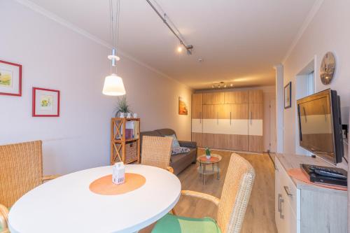 a kitchen and living room with a table and chairs at Haus Knechtsand, Whg 433 in Cuxhaven