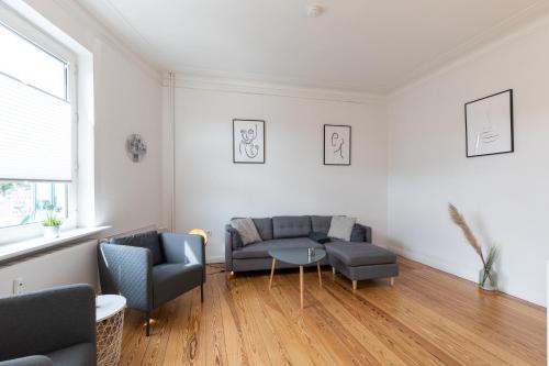 a living room with a couch and a table at Wohnung Deichbude in Cuxhaven