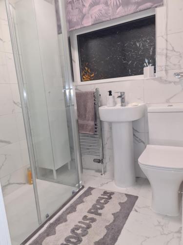 a bathroom with a toilet and a sink and a shower at Semi detached quite location in Bridlington