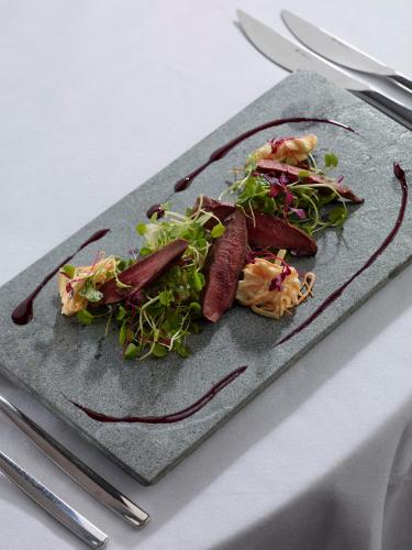 a plate of food on a table with a salad at Warwick Conferences - Scarman in Coventry
