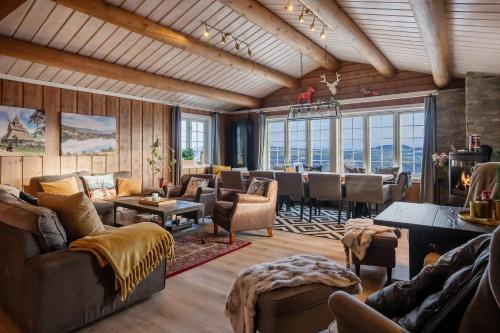 a living room with couches and chairs and windows at TH616- Large ski-in out cabin in Trysilfjell for 14 guests in Trysil
