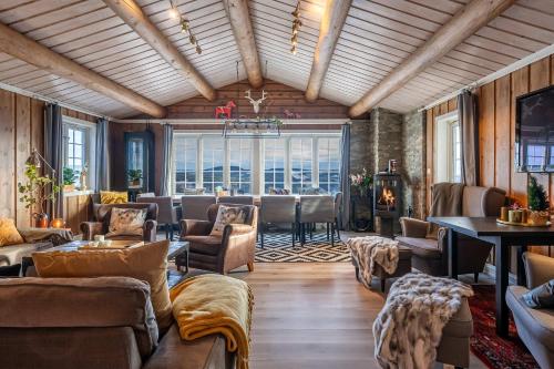 a living room with couches and chairs and a table at TH616- Large ski-in out cabin in Trysilfjell for 14 guests in Trysil
