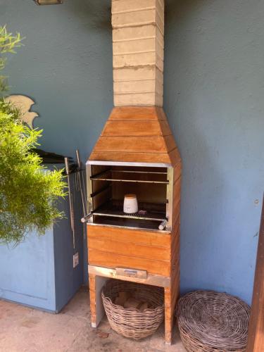 a wooden stand with a shelf on the side of a building at Casa5 in Arraial d'Ajuda