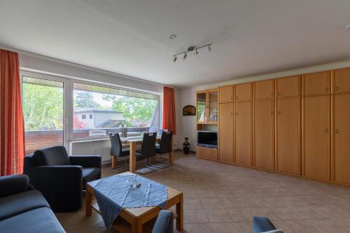a living room with a couch and a table at Haus Luv und Lee Wohnung 26 in Döse