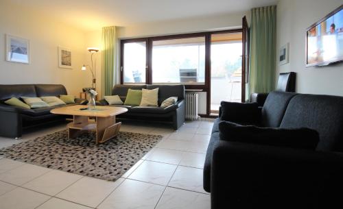 a living room with couches and a coffee table at Haus Seehund, Whg 13 in Cuxhaven