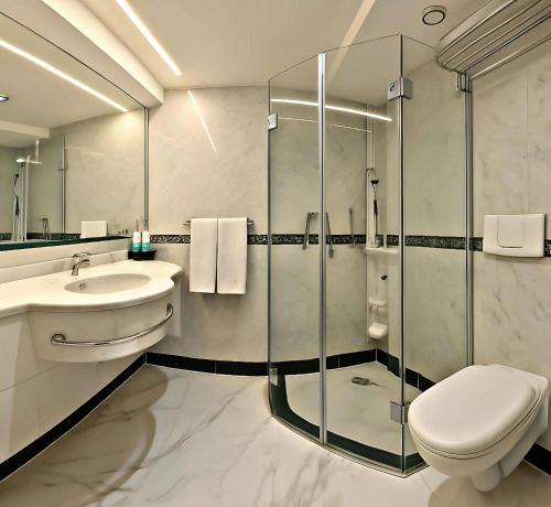 a bathroom with a toilet and a sink and a shower at Five-Star Deluxe River Kruz from Aswan to Luxor 3 Nights in Aswān