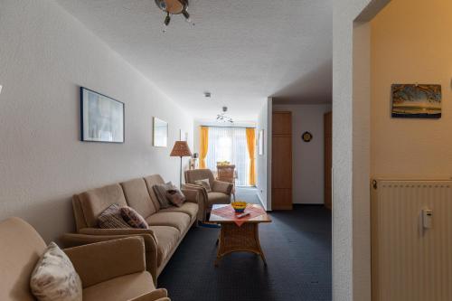 a living room with a couch and a table at Haus Elbe 1, Whg 11 in Duhnen