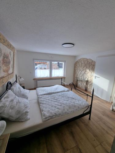 a bedroom with a large bed in a room at Ferienwohnung Braun in Longkamp