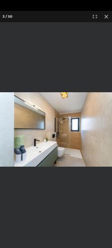 a bathroom with a white sink and a mirror at Petra in Biograd na Moru
