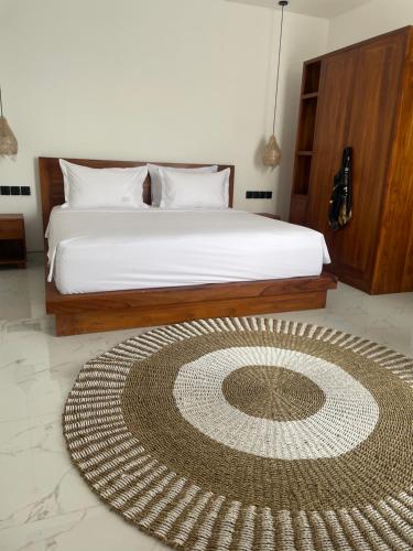 a bedroom with a bed with a large rug on the floor at Villa Elina 09 in Badung