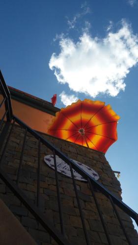 an orange umbrella sitting on top of a building at Affittacamere Elisabetta in Vernazza