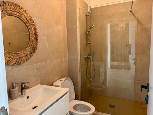 a bathroom with a toilet and a sink and a shower at Alezzi Infiniti Resort & SPA - SUNRISE 349 in Năvodari