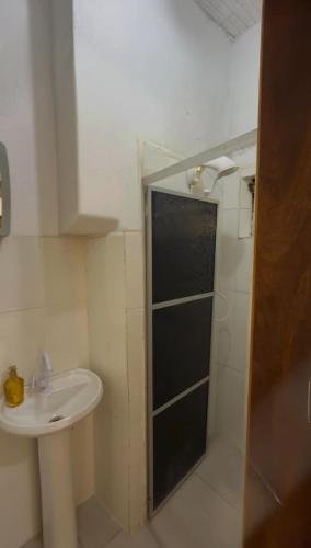 a bathroom with a sink and a shower at Casa privada no Centro in São Gabriel