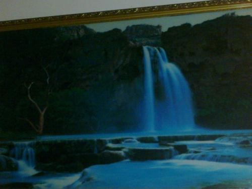 a painting of a waterfall in a picture at Hotel Remix in Cameron Highlands