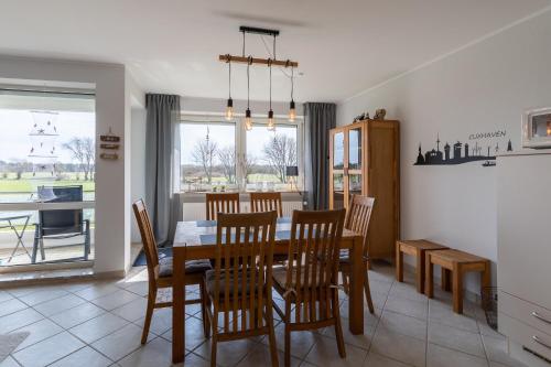a kitchen and dining room with a table and chairs at Haus Vogelsand, App 309 in Duhnen