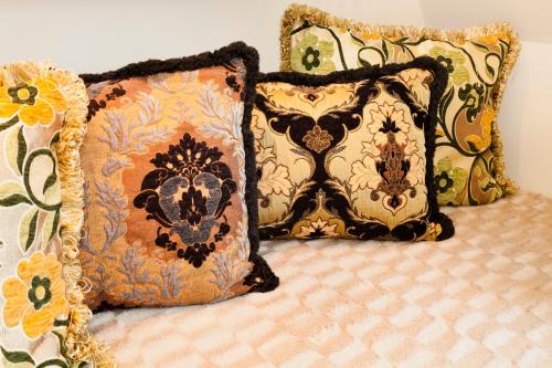 a bed with two pillows and two pillows on it at Hotel Diamonds and Pearls in Antwerp