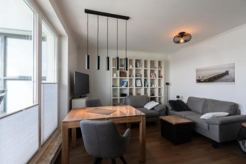 a living room with a table and a couch at Haus Medemsand, Whg 221 in Duhnen