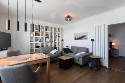 a living room with a couch and a table at Haus Medemsand, Whg 221 in Duhnen