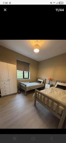 a large room with two beds and a window at Seaview House in Donegal