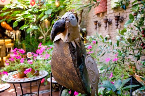 a statue of a bird wearing glasses in a garden at Hotel Diamonds and Pearls in Antwerp