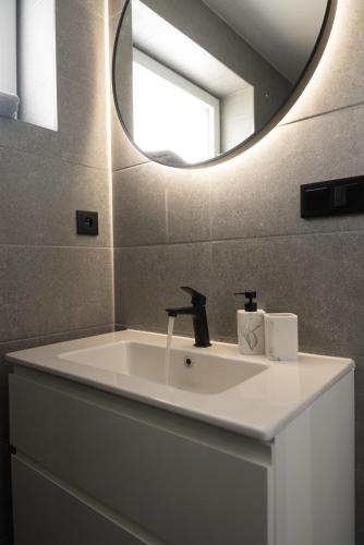 a bathroom with a sink and a mirror at Horský sen - Mountain Dream Apartment B1 in Špičák